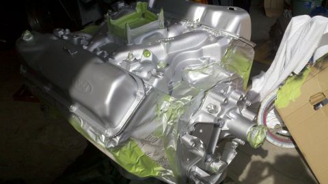 1978 Ford Bronco - Ford V8 engine block and parts masked for painting, likely during a rebuild.
