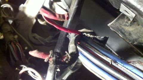 1978 Ford Bronco - Damaged wiring harness shows frayed red and blue wires, indicating a potential electrical issue.