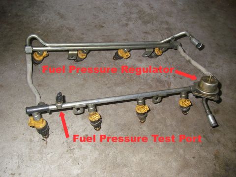 1990 Ford Bronco - This image shows a fuel rail assembly with injectors, a fuel pressure regulator, and a fuel pressure test port.