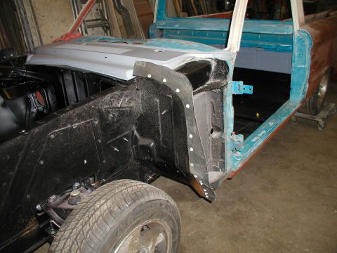1960 Ford Ranchero - 1960 Ford Ranchero body undergoing restoration, with front fender removed to expose engine bay.