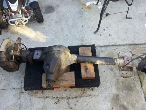1978 Ford Bronco - A disassembled Dana 60 axle assembly is shown resting on wooden blocks on a concrete surface.