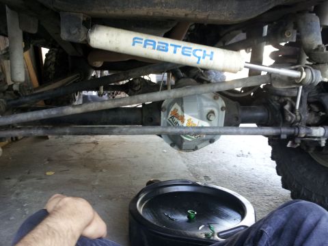 1978 Ford Bronco - Undercarriage view shows a Fabtech shock and a Dana 60 differential, possibly from a modified vehicle.