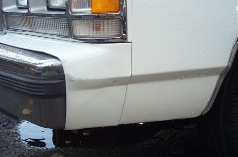 1991 Ford LTD Crown Victoria - Front corner of a white 1991 Ford Crown Victoria LTD, showing the headlight, turn signal, and chrome bumper detail.