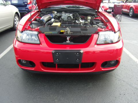2007 Ford Mustang - Front view of a red Ford Mustang with its hood open, revealing the engine compartment.