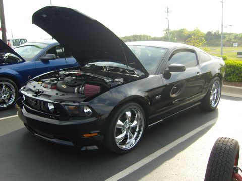 2007 Ford Mustang - Black 2007 Ford Mustang GT at a car meet, hood raised to display the engine bay.