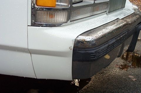 1991 Ford LTD Crown Victoria - Front corner of a 1991 Ford Crown Victoria LTD shows chrome bumper and turn signal light.