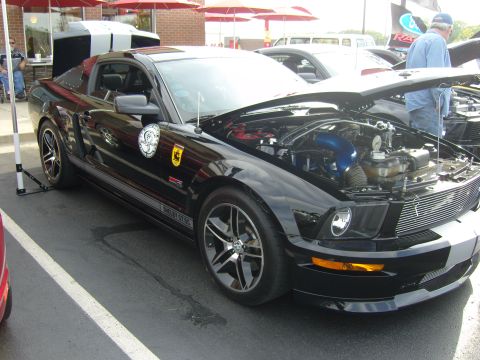2007 Ford Mustang - A black 2007 Ford Mustang Shelby GT500 is displayed with its hood open at a car show.