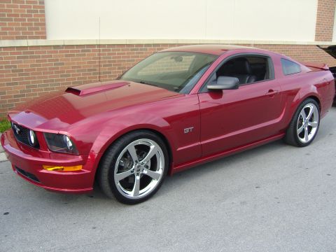 2007 Ford Mustang - This red Ford Mustang GT features a distinctive hood scoop and stylish chrome wheels.