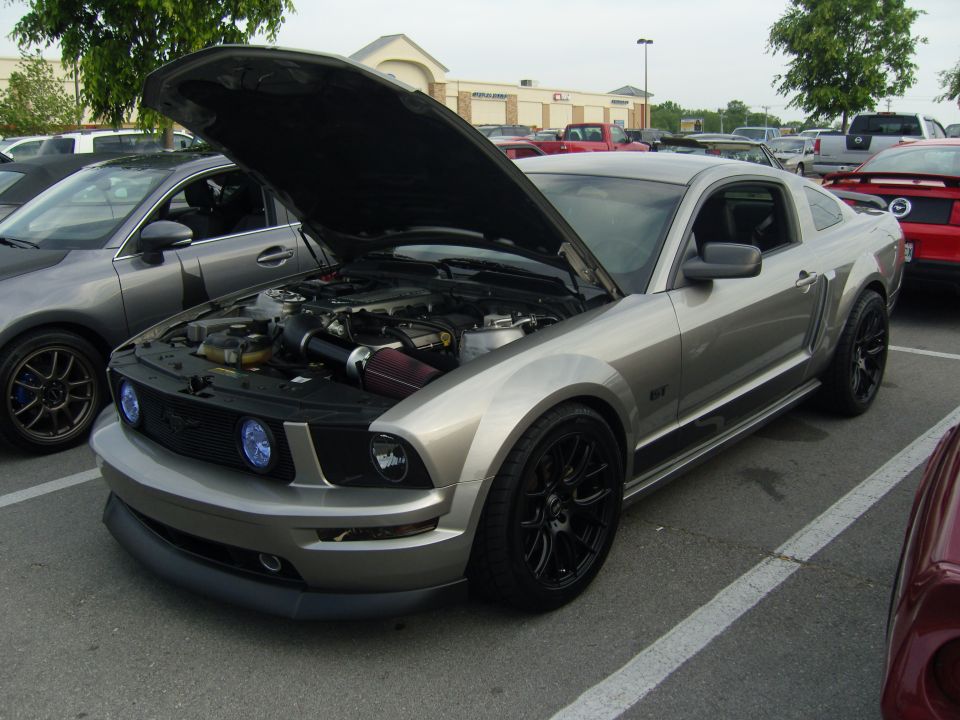 Silver 2007 Ford Mustang GT with hood open, parked next to a grey car
