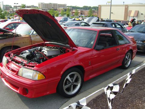2007 Ford Mustang - A red coupe, likely a 1987 Ford Mustang, is displayed with its hood open at a car show.