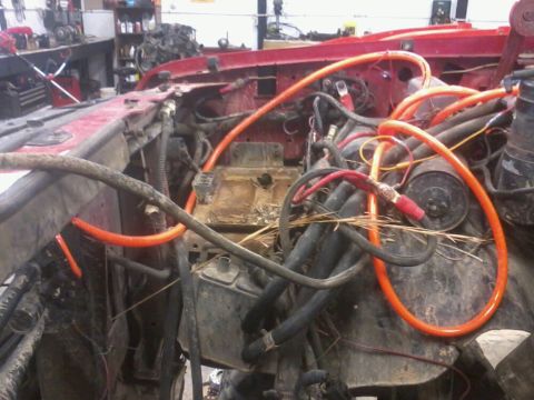 1995 Ford F-150 - Dual battery tray and isolator installed in an engine bay, with prominent orange cabling.