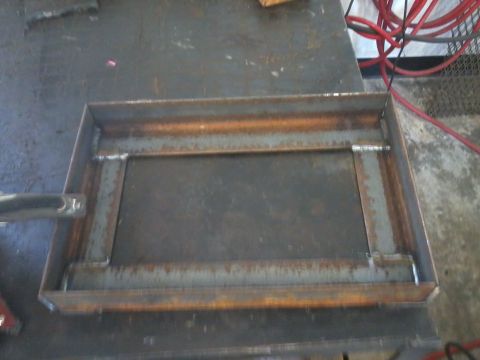 1995 Ford F-150 - A metal dual battery tray with an isolator is shown, likely for a vehicle's electrical system.