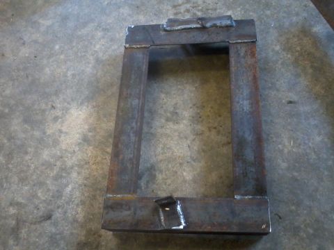 1995 Ford F-150 - A custom-made metal bracket, likely for automotive use, is shown on a concrete surface.