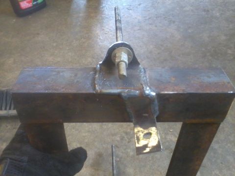 1995 Ford F-150 - A close-up view of a custom-welded metal bracket with a threaded rod and hardware attached.
