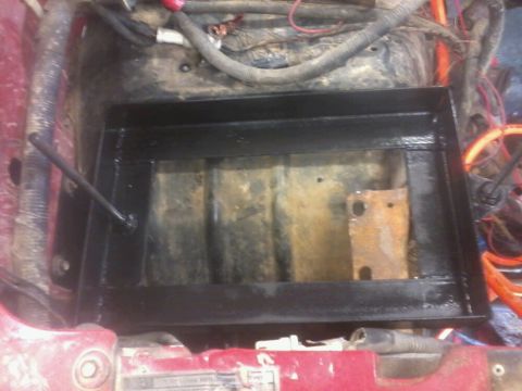 1995 Ford F-150 - A dual battery tray with an isolator is shown installed in a vehicle's engine bay.