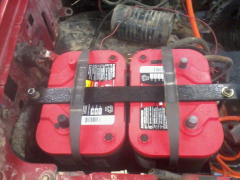 1995 Ford F-150 - A dual battery setup two red Optima batteries is visible, secured with a metal tray and straps.