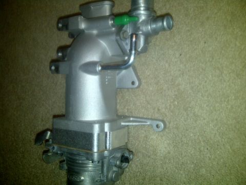 2000 Ford Crown Victoria - A silver throttle body is shown against a carpeted background.