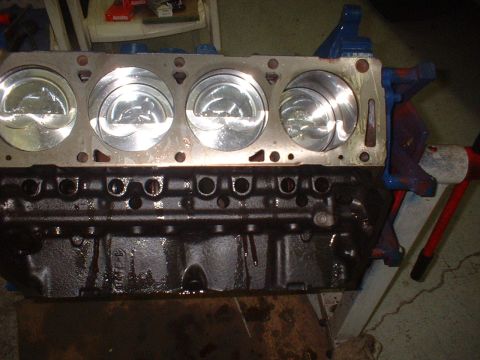 1957 Ford Custom Sedan - Close-up of an engine block with pistons, showing internal engine components.