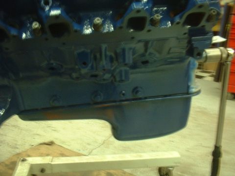 1957 Ford Custom Sedan - Close-up of a blue painted engine block, likely undergoing restoration or repair.