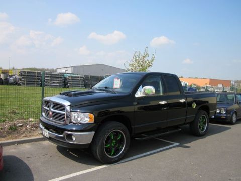 1991 Ford LTD Crown Victoria - A black Dodge Ram pickup truck is parked in a lot with another vehicle visible behind it.