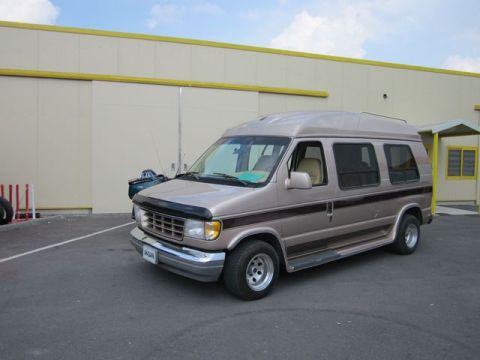 1991 Ford LTD Crown Victoria - This Ford Econoline van, likely from the early 1990s, features a distinctive raised roof and dual-tone paint scheme.