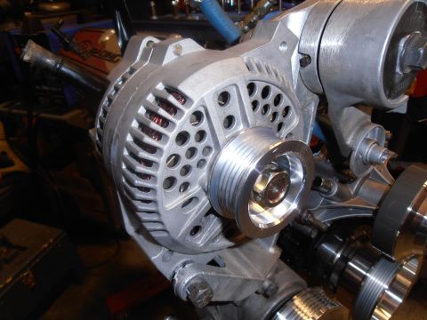 1990 Ford Bronco - This is a close-up view of an automotive alternator with its pulley system.
