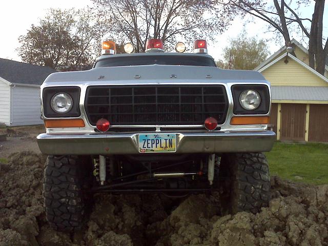 Front view of a 1978 Ford Bronco with emergency lights and a custom license plate