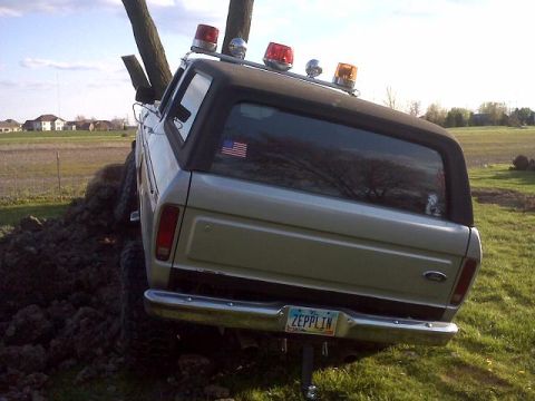 1978 Ford Bronco - This 1978 Ford Bronco is stuck in a dirt pile, with emergency lights mounted on its roof.