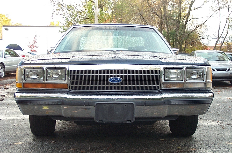 Front view of a 1991 Ford Crown Victoria LTD with a chrome grille and Ford emblem
