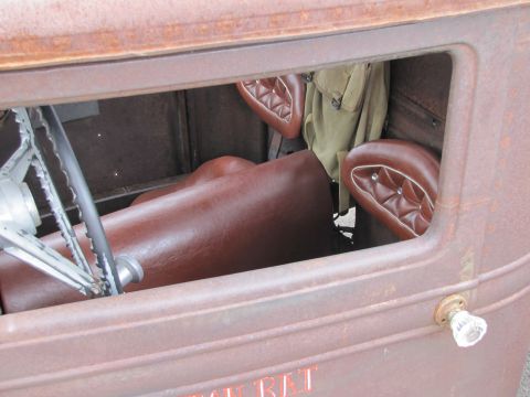 2006 BMW 5 Series - Rusty interior of a vintage truck, brown diamond-stitched seats and a classic steering wheel.