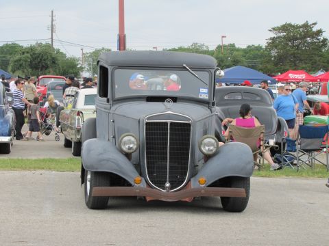2006 BMW 5 Series - A classic pickup truck is parked at an outdoor event with other vehicles and spectators around.