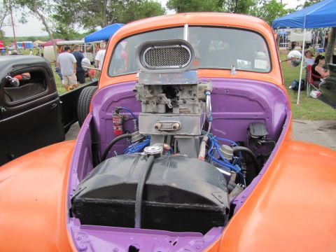2006 BMW 5 Series - Custom hot rod with a powerful engine on display at an outdoor car show.