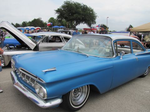 2006 BMW 5 Series - A blue 1959 Chevrolet sedan is parked next to another classic car at an outdoor event.