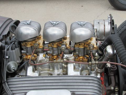 2006 BMW 5 Series - V8 engine with triple carburetors and finned air cleaners, likely from a hot rod.