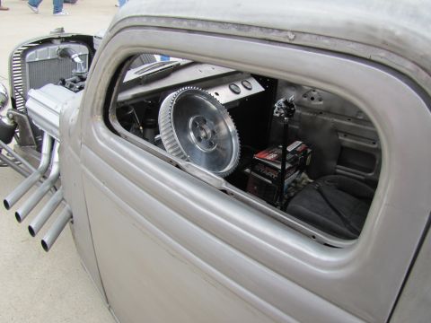 2006 BMW 5 Series - A custom hot rod features a large metal steering wheel and exposed engine components, with prominent side pipes.