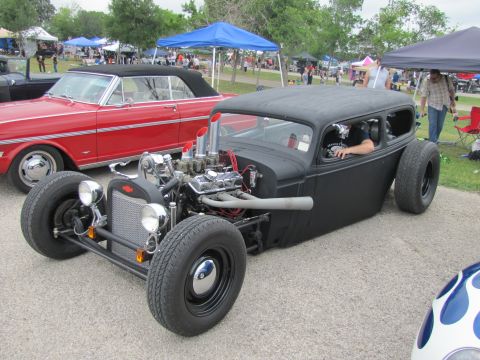 2006 BMW 5 Series - Custom hot rod with a powerful engine on display at an outdoor car show.