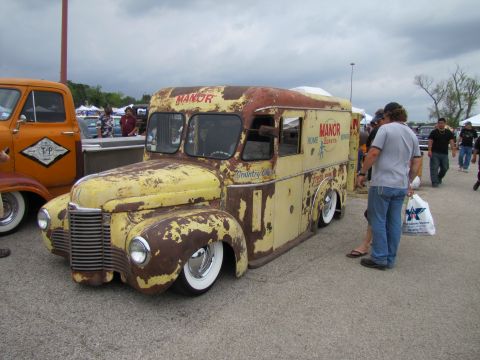 2006 BMW 5 Series - This vintage ice cream truck, branded 'MANOR', displays significant rust and a lowered stance, seen at an outdoor event.