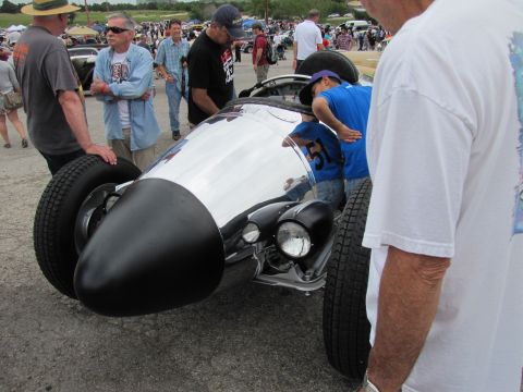 2006 BMW 5 Series - People gather around a custom hot rod at an outdoor car show.