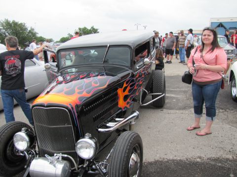 2006 BMW 5 Series - A custom hot rod with flame graphics is displayed outdoors with other vehicles and people.