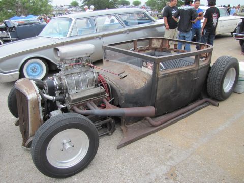 2006 BMW 5 Series - A heavily modified hot rod sits parked next to a vintage station wagon.