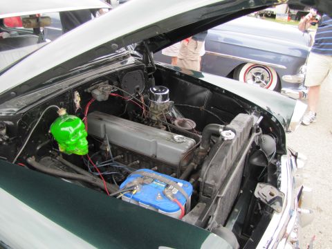 2006 BMW 5 Series - The engine bay features a unique green skull-shaped washer fluid reservoir and a prominent blue battery.