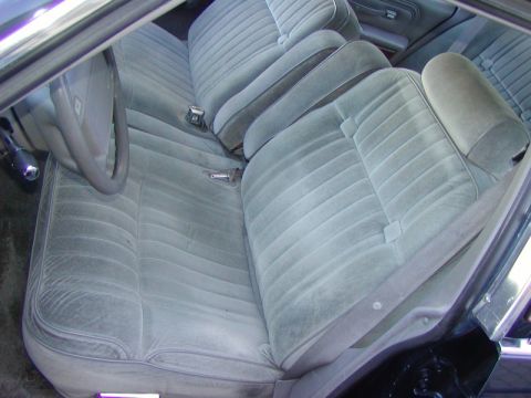 1991 Ford LTD Crown Victoria - Interior view of light blue velour seats and steering wheel.