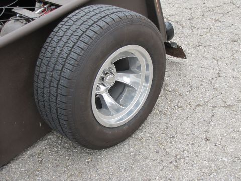 2006 BMW 5 Series - A close-up view of a chrome five-spoke wheel mounted on a tire, part of a custom hot rod.