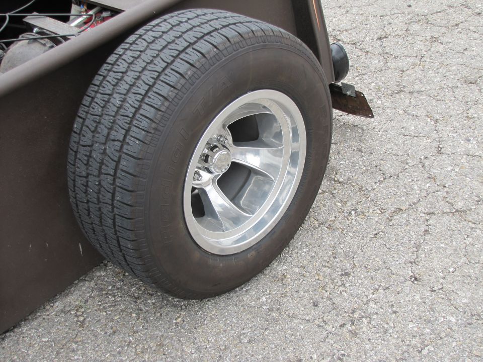 Chrome five-spoke wheel on a custom hot rod tire