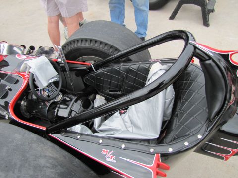2006 BMW 5 Series - Interior view of a custom racing car with a roll cage and diamond-stitched seats.