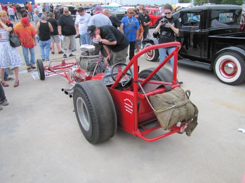 2006 BMW 5 Series - A custom dragster is on display at an outdoor event, with spectators observing.