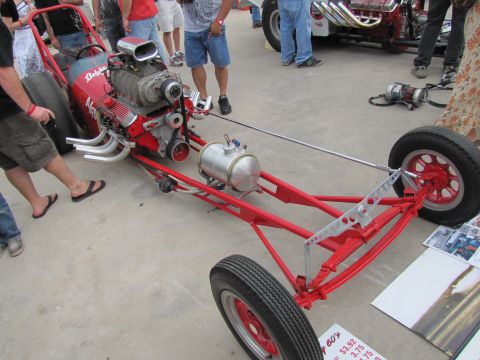 2006 BMW 5 Series - A custom-built dragster chassis with a powerful V8 engine is on display at an outdoor event.