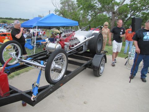 2006 BMW 5 Series - A dragster with a V8 engine is loaded onto a trailer at an outdoor event.