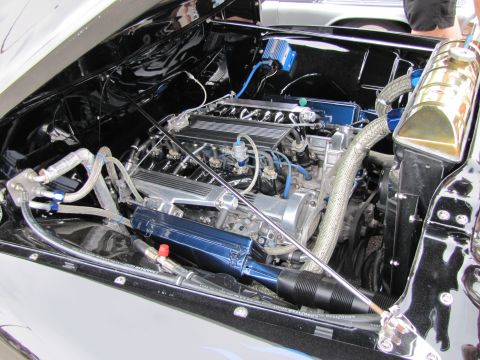 2006 BMW 5 Series - Close-up view of a custom V8 engine bay, highlighting polished metal and vibrant blue accessories.