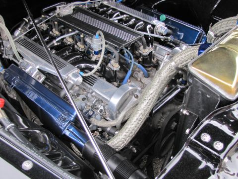 2006 BMW 5 Series - Detailed view of a customized engine bay chrome components and braided hoses.